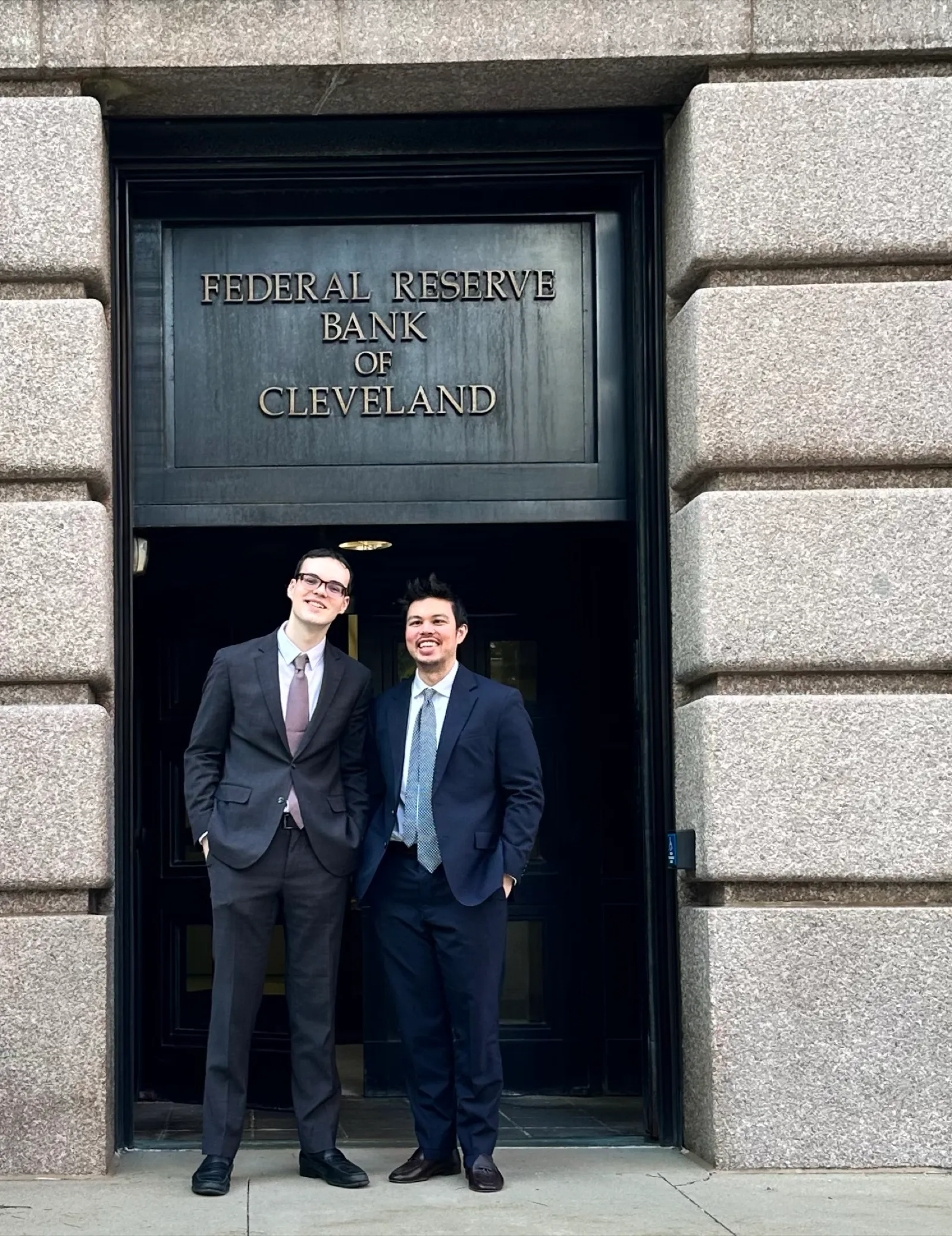 Tyler Sotomayor and Gabriel Uceda-Sosa at the entrance of the Federal Reserve Bank of Cleveland