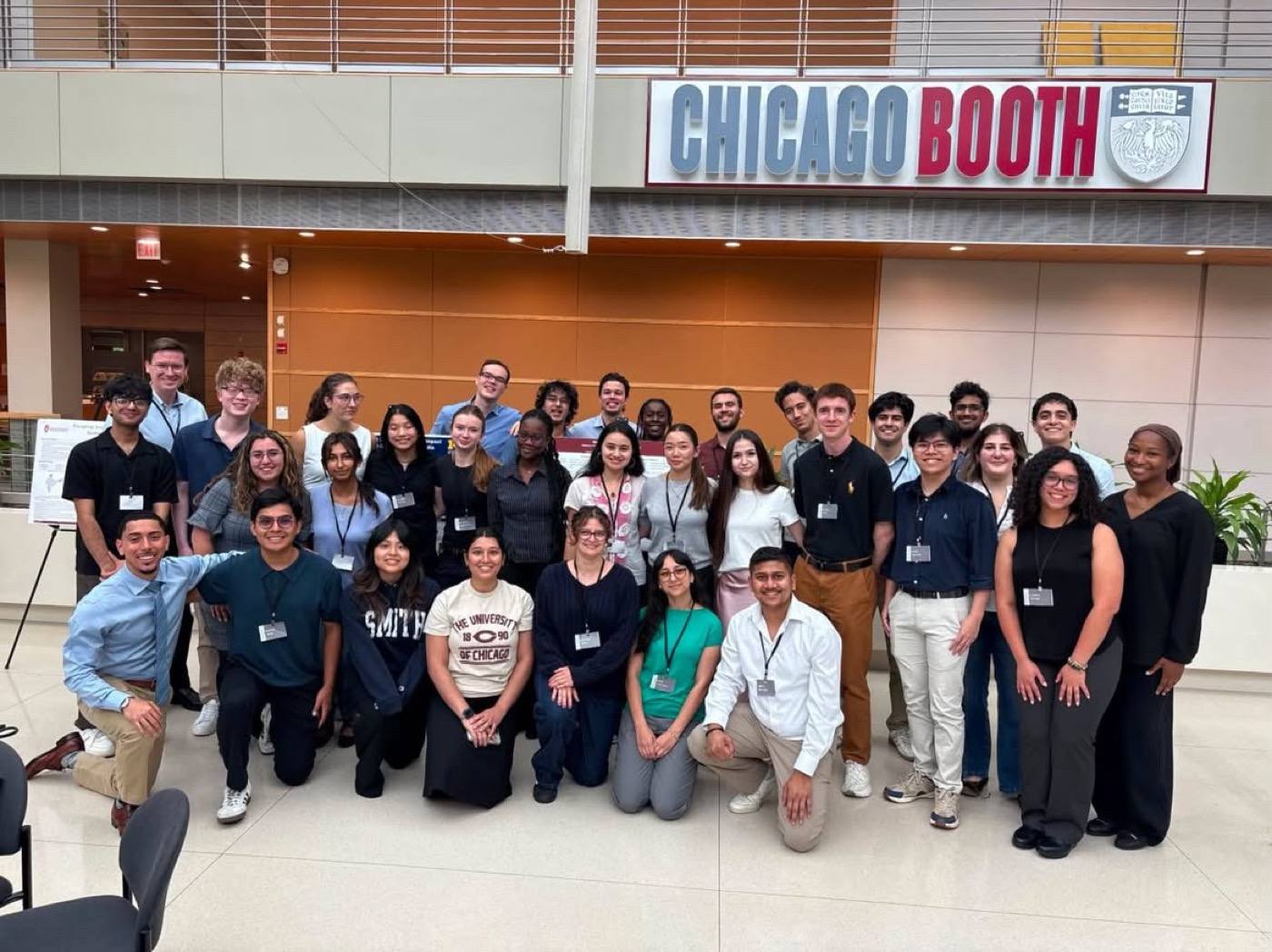 The PREDOC Summer Research Conference cohort under the Chicago Booth sign