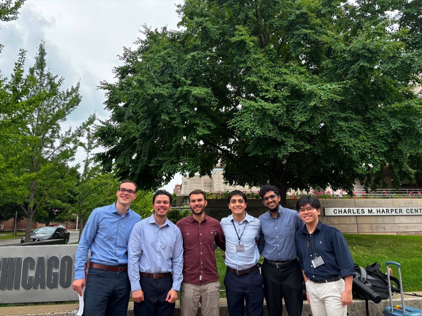 Six conference attendees outside the Charles M. Harper Center at the University of Chicago