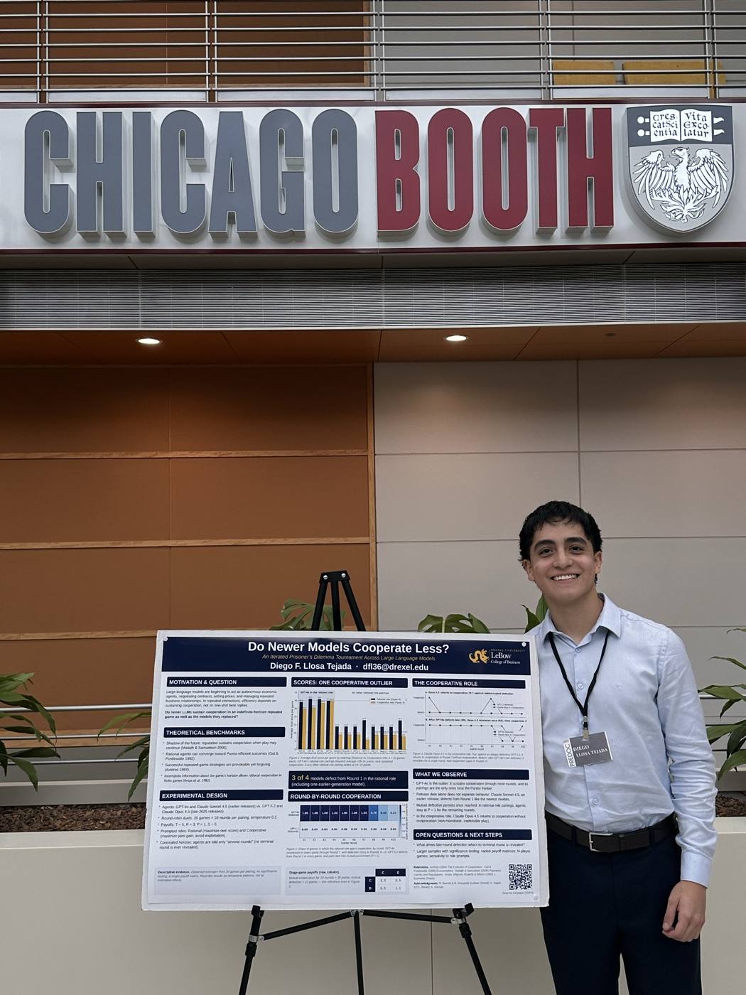 Diego beside his poster on cooperation among large language models